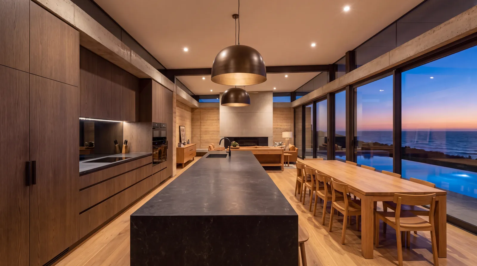 The kitchen island and dining table beside the pool glass